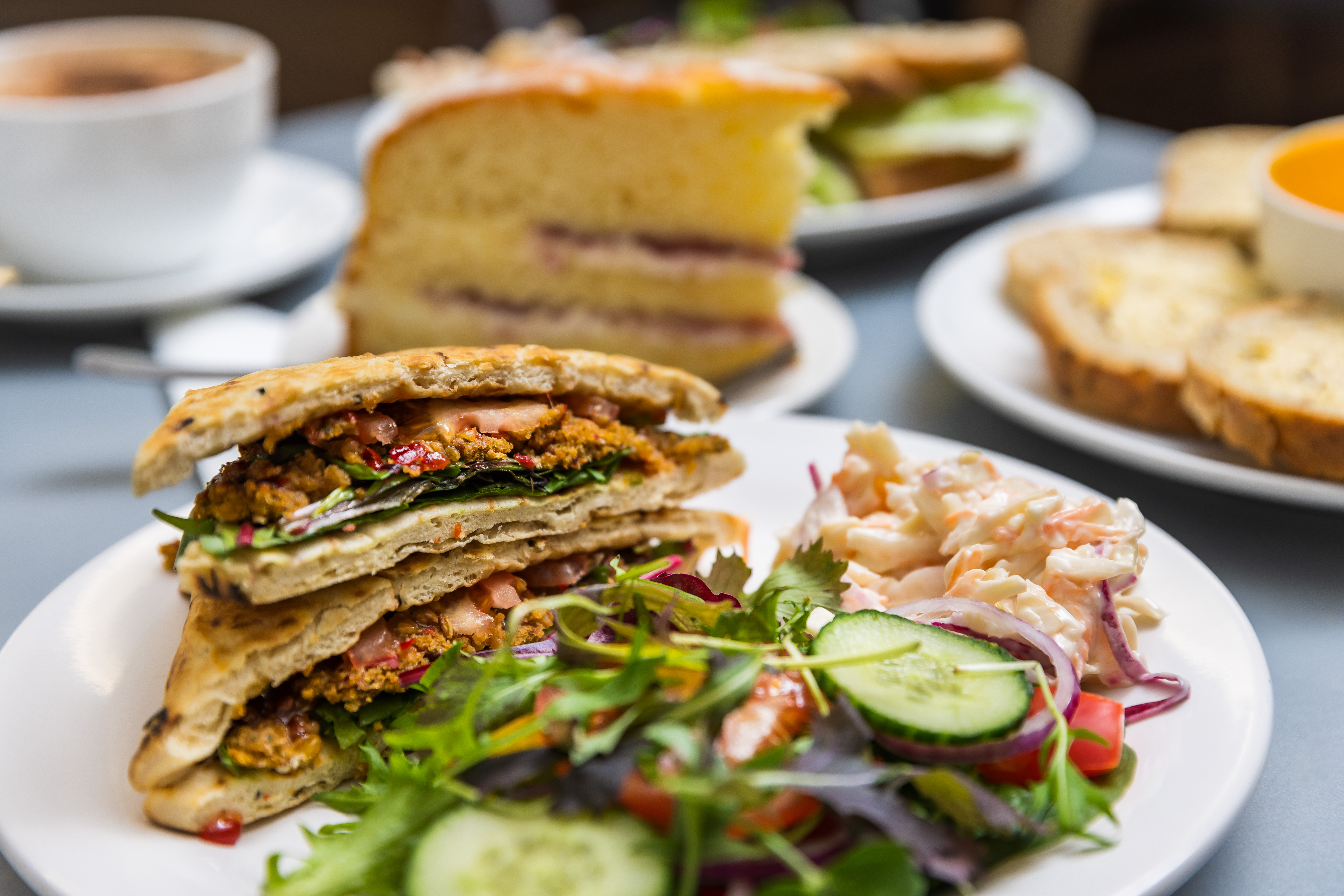 Photo of a menu item: warm flatbread with a salad garnish and coleslaw