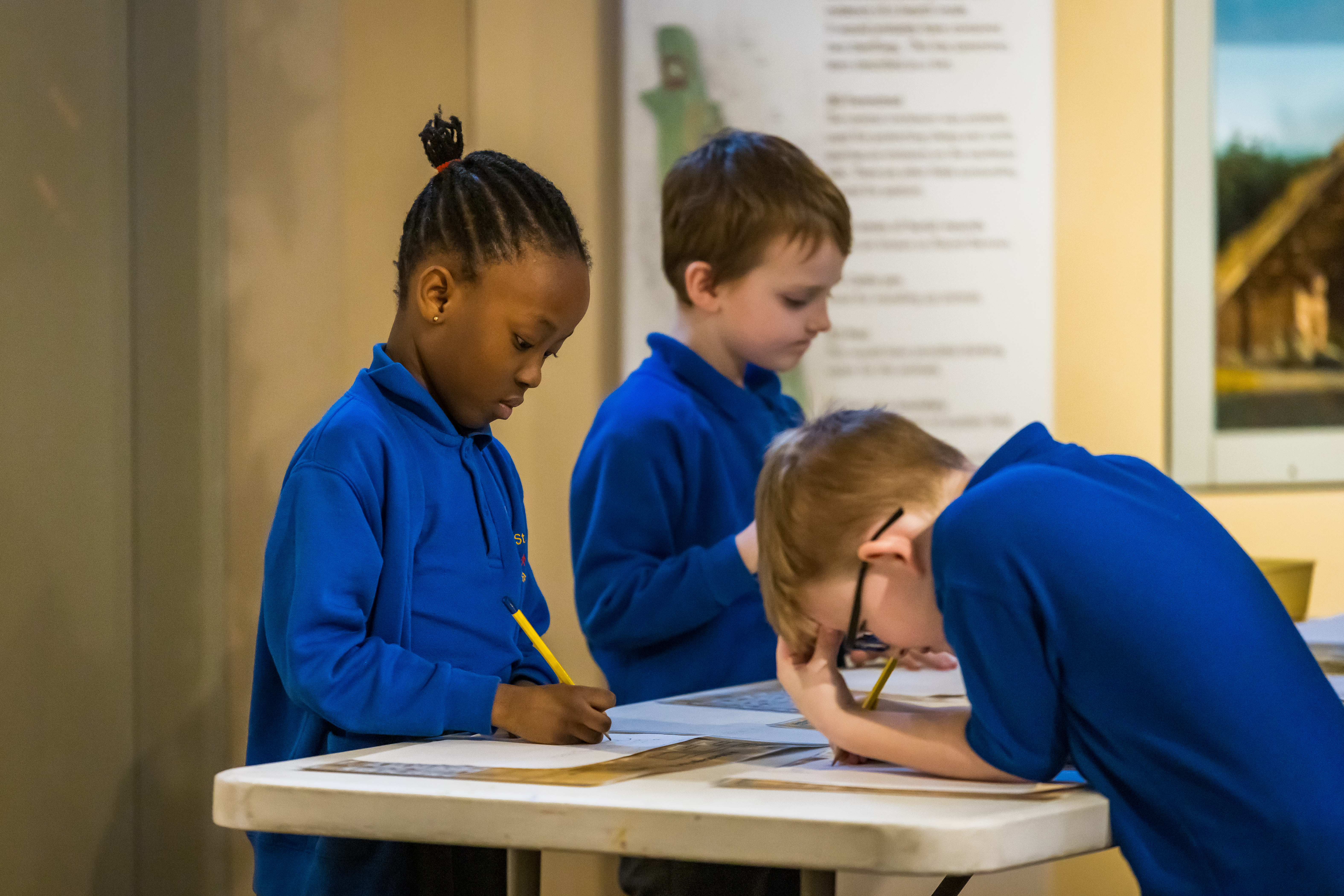 Children writing in workbooks