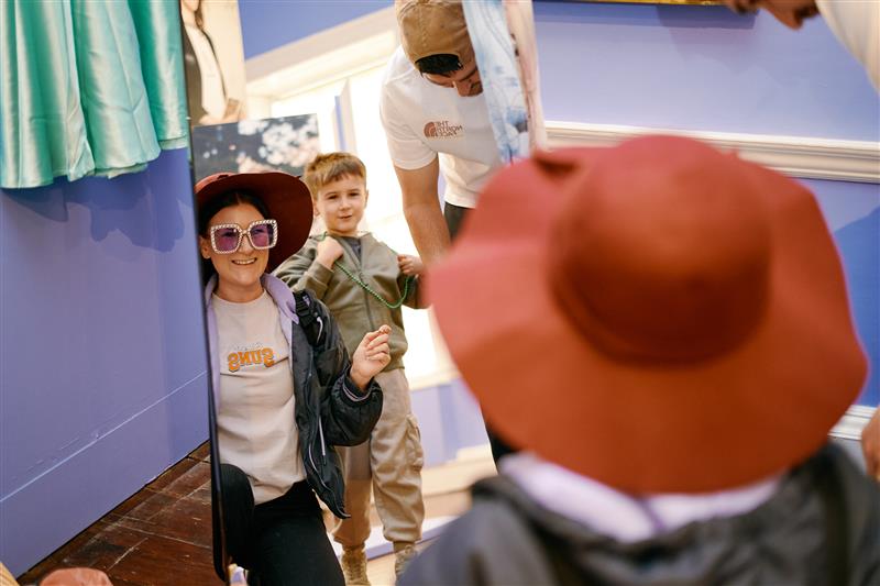 Visitors at the museum dressing up in fancy accessories