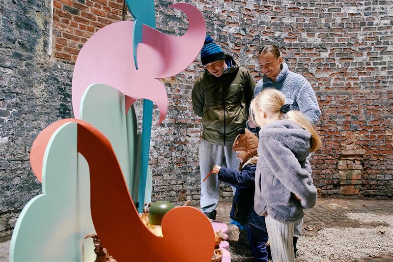 family stoof looking at the pottery pieces art exhibition inside the waterloo kiln